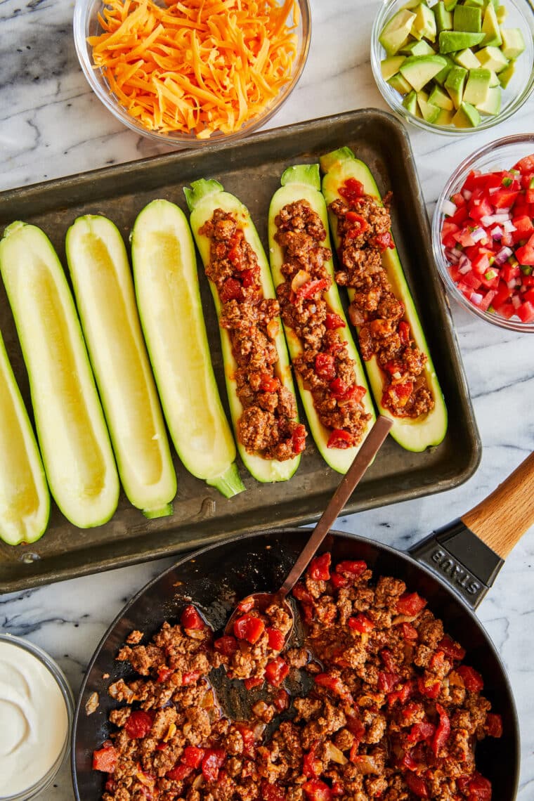 Taco Zucchini Boats - A low-carb dinner recipe for the whole family! Stuffed with ground beef and taco seasoning, baked to cheesy perfection.